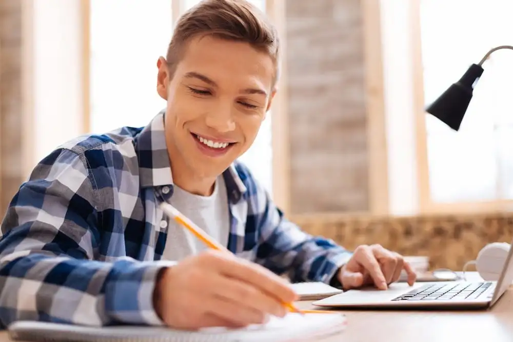 A student smiling while studying-cant relate